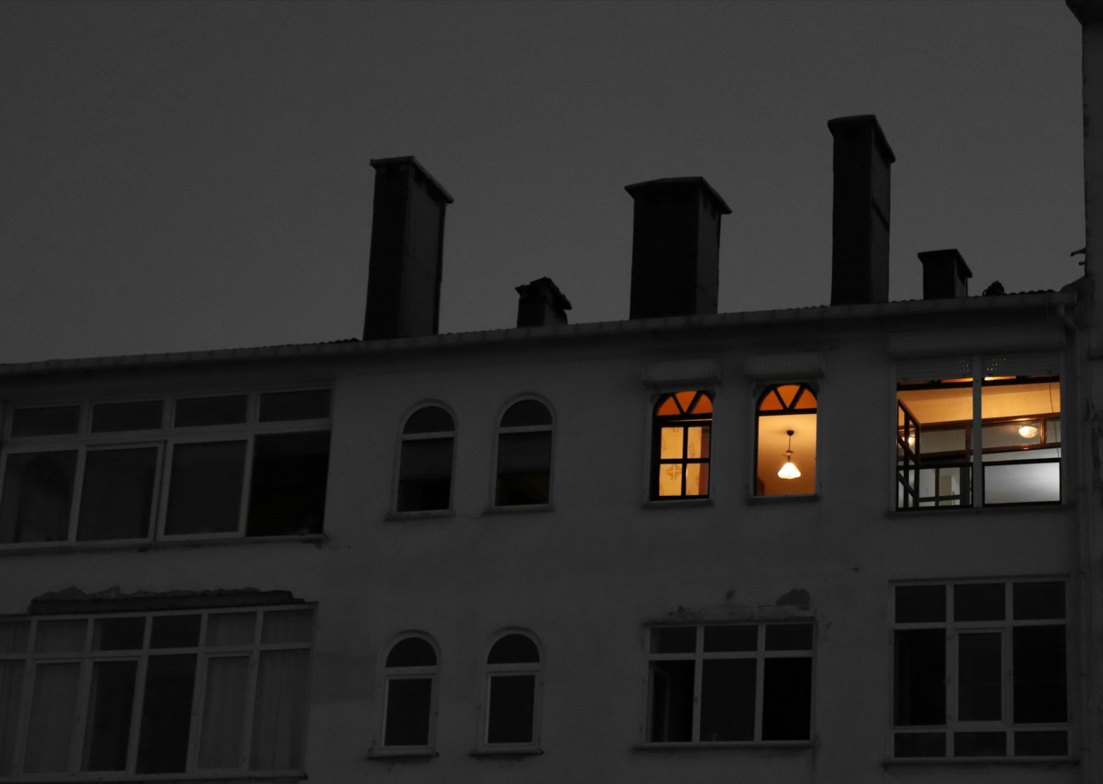 white concrete building with lights turned on during night time